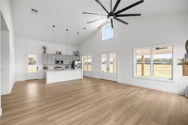 2212 SW 210th Ave, Dunnellon, FL 34431 - unfurnished living room featuring a ceiling fan, high vaulted ceiling, french doors, and light wood-style flooring