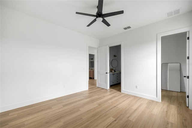 2212 SW 210th Ave, Dunnellon, FL 34431 - unfurnished bedroom featuring light wood-style floors, ensuite bath, and a ceiling fan