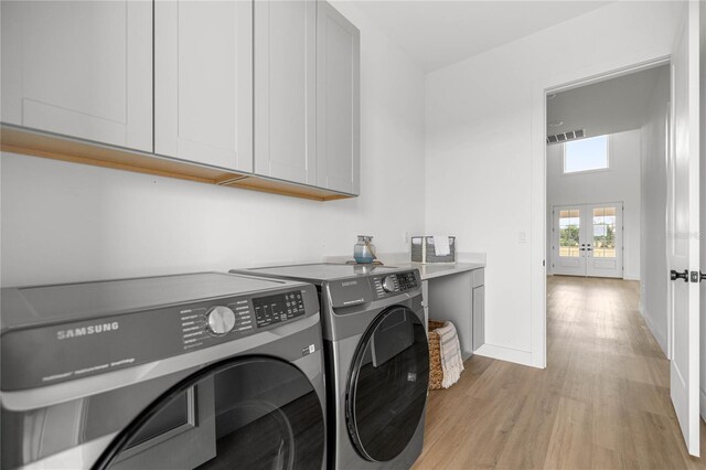 2212 SW 210th Ave, Dunnellon, FL 34431 - laundry area with separate washer and dryer, cabinet space, french doors, and light wood finished floors