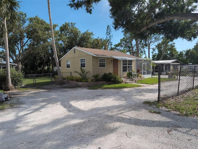 417 Shore Rd, Nokomis, FL 34275 - view of front facade featuring dirt driveway and a gate