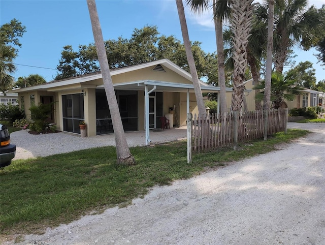 417 Shore Rd, Nokomis, FL 34275 - view of front of house featuring a sunroom and stucco siding