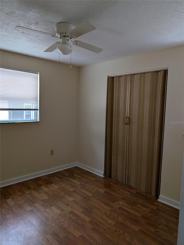 417 Shore Rd, Nokomis, FL 34275 - unfurnished bedroom featuring dark wood-type flooring and a ceiling fan