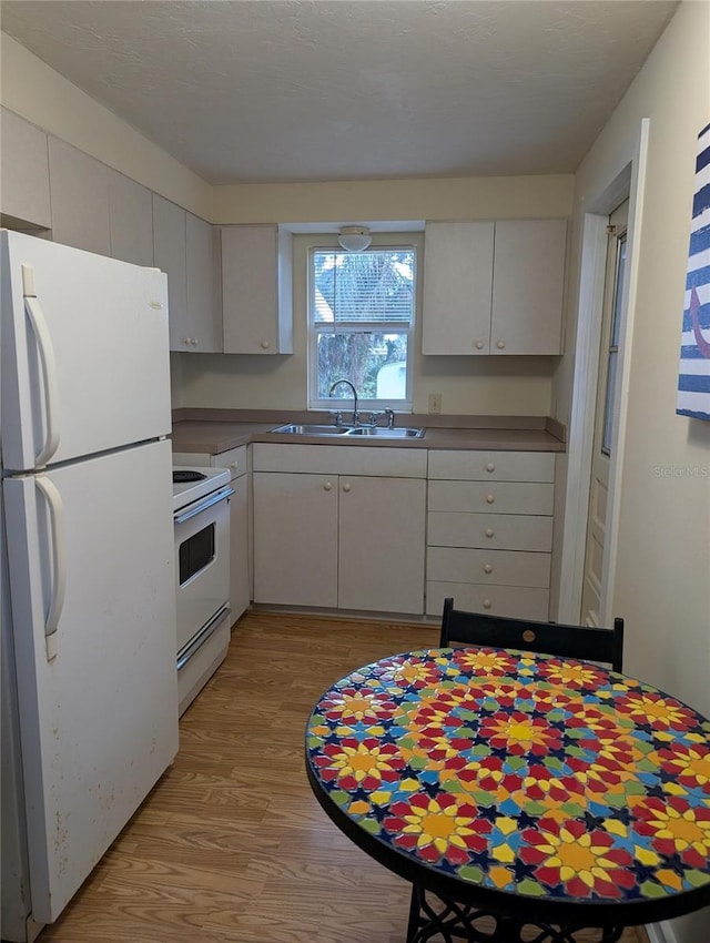417 Shore Rd, Nokomis, FL 34275 - kitchen with white appliances and light wood-type flooring