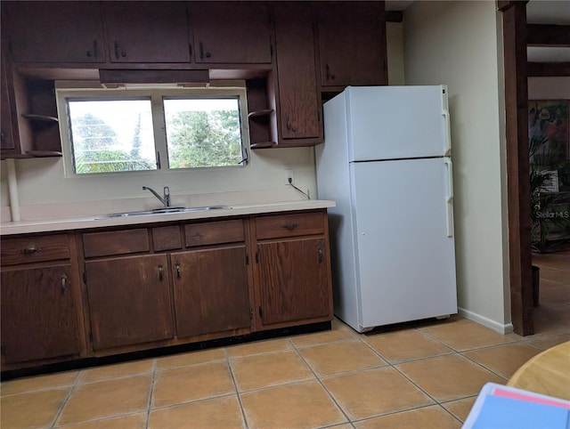 417 Shore Rd, Nokomis, FL 34275 - kitchen with freestanding refrigerator, open shelves, light countertops, and light tile patterned flooring