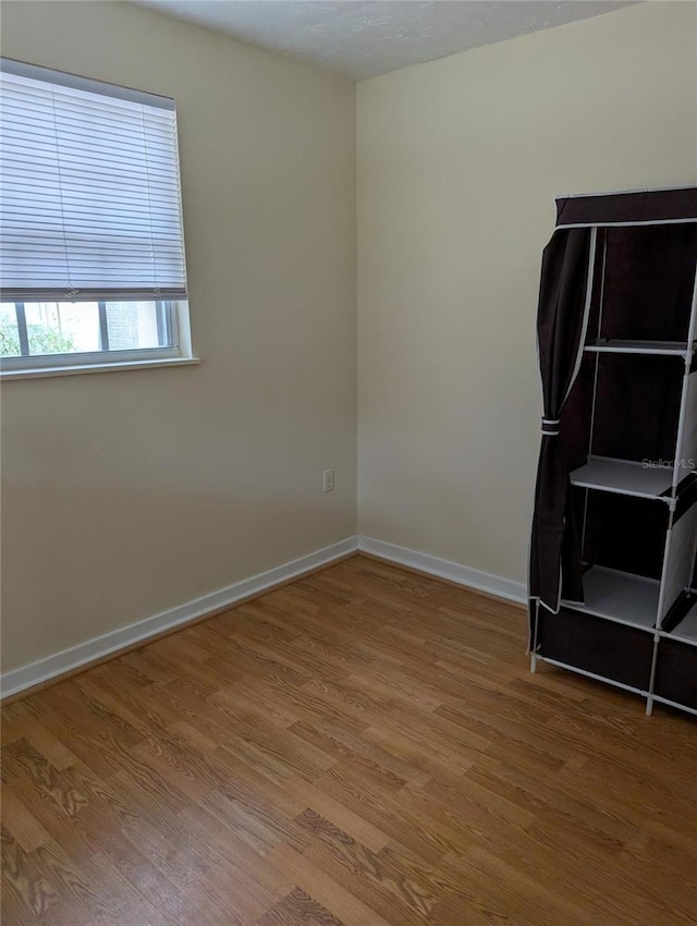 417 Shore Rd, Nokomis, FL 34275 - empty room with wood finished floors and baseboards