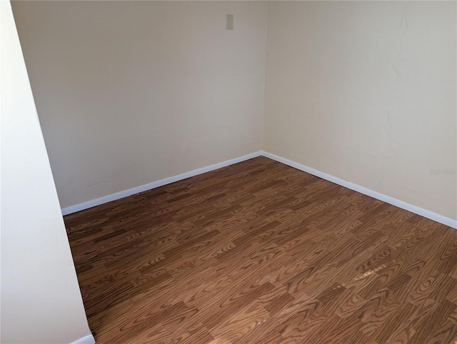 417 Shore Rd, Nokomis, FL 34275 - spare room featuring dark wood-style floors and baseboards