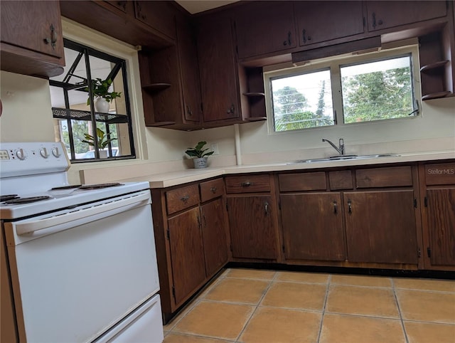 417 Shore Rd, Nokomis, FL 34275 - kitchen featuring white range with electric cooktop, open shelves, light countertops, and light tile patterned flooring