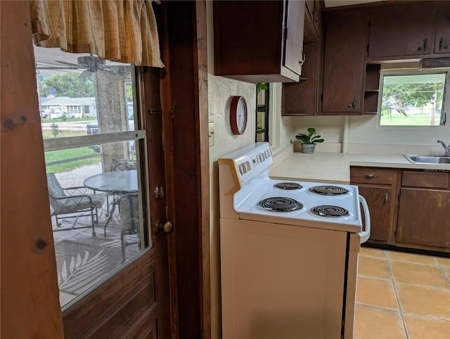 417 Shore Rd, Nokomis, FL 34275 - kitchen featuring electric stove, light countertops, and light tile patterned floors
