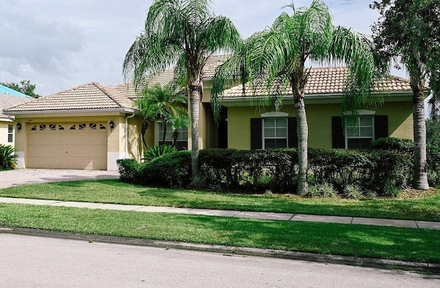 3504 Shorewood Dr, Kissimmee, FL 34746 - view of front of property featuring stucco siding, a tile roof, and a garage