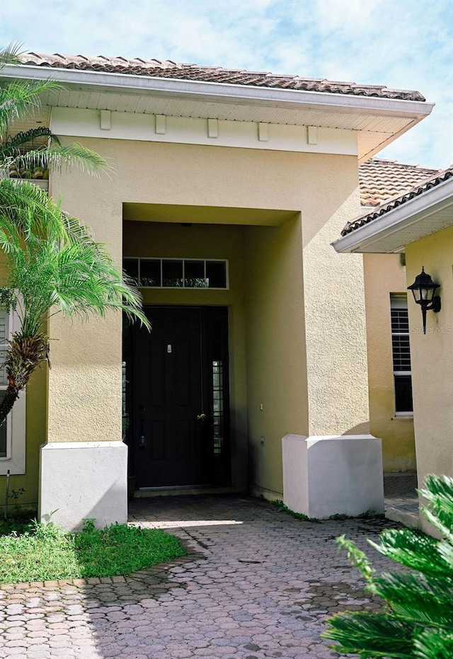 3504 Shorewood Dr, Kissimmee, FL 34746 - property entrance with stucco siding and a tile roof