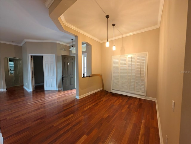 3504 Shorewood Dr, Kissimmee, FL 34746 - spare room featuring arched walkways, wood finished floors, and crown molding
