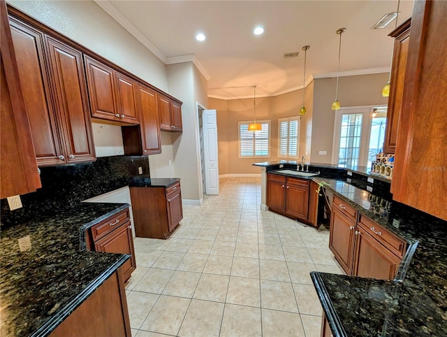 3504 Shorewood Dr, Kissimmee, FL 34746 - kitchen with tasteful backsplash, decorative light fixtures, ornamental molding, light tile patterned flooring, and dark stone counters
