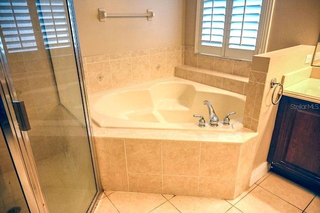 3504 Shorewood Dr, Kissimmee, FL 34746 - full bath featuring a bath, a shower stall, tile patterned flooring, and vanity
