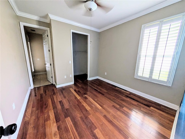 3504 Shorewood Dr, Kissimmee, FL 34746 - unfurnished bedroom with dark wood-type flooring, ornamental molding, a closet, and a ceiling fan