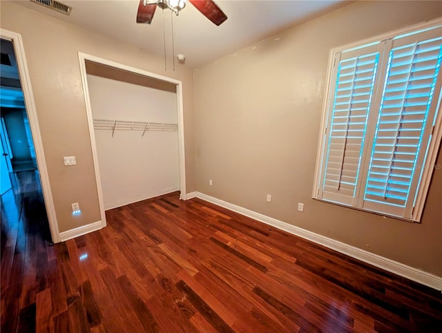 3504 Shorewood Dr, Kissimmee, FL 34746 - unfurnished bedroom with wood finished floors, a closet, and a ceiling fan