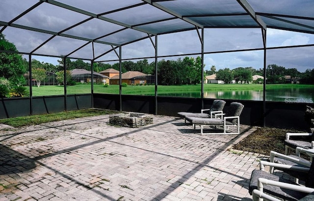 3504 Shorewood Dr, Kissimmee, FL 34746 - view of patio with a water view, a lanai, and an outdoor fire pit