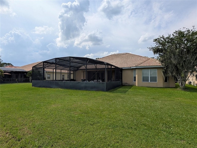 3504 Shorewood Dr, Kissimmee, FL 34746 - back of house with a lawn, stucco siding, a tile roof, and a lanai