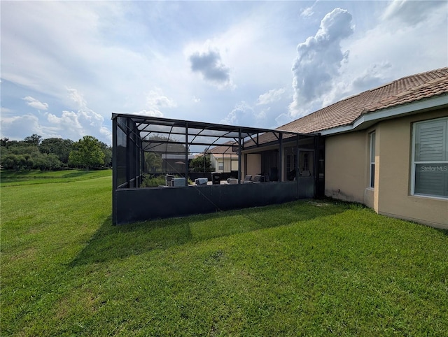 3504 Shorewood Dr, Kissimmee, FL 34746 - back of property featuring stucco siding, a yard, a lanai, and a tiled roof