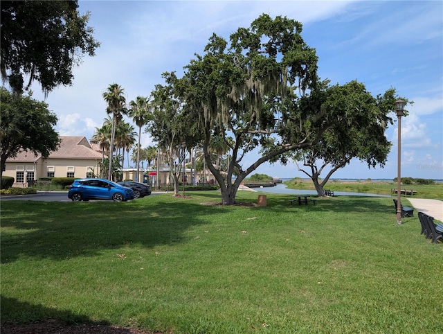 3504 Shorewood Dr, Kissimmee, FL 34746 - view of home's community with a lawn and a water view