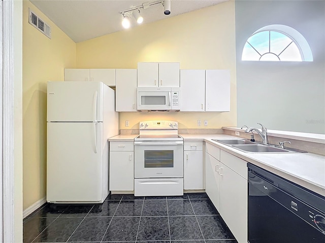 1751 Chatham Cir, Apopka, FL 32703 - kitchen featuring white appliances, vaulted ceiling, dark tile patterned floors, track lighting, and white cabinets