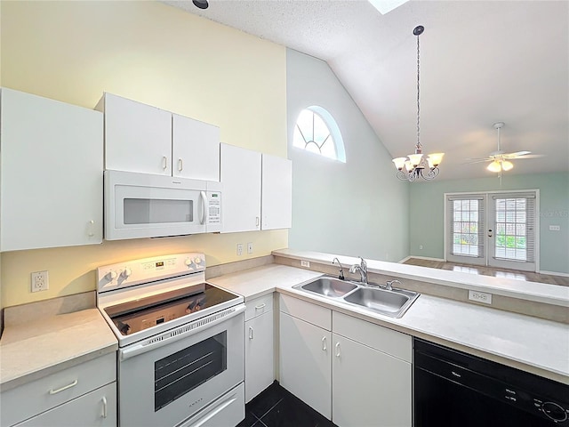 1751 Chatham Cir, Apopka, FL 32703 - kitchen featuring white appliances, vaulted ceiling, light countertops, healthy amount of natural light, and decorative light fixtures