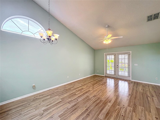 1751 Chatham Cir, Apopka, FL 32703 - unfurnished room featuring vaulted ceiling, wood finished floors, ceiling fan, a chandelier, and french doors
