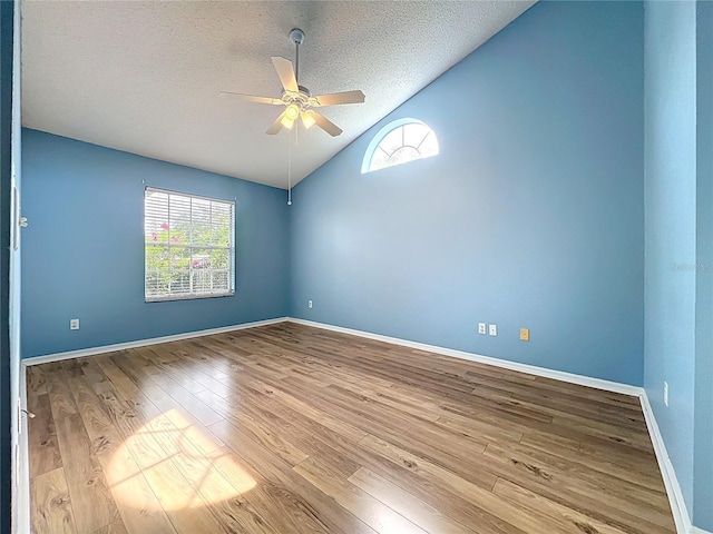 1751 Chatham Cir, Apopka, FL 32703 - empty room with ceiling fan, lofted ceiling, wood finished floors, and a textured ceiling