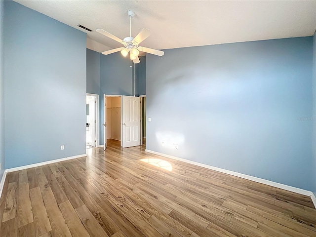 1751 Chatham Cir, Apopka, FL 32703 - unfurnished room with high vaulted ceiling, wood finished floors, and a ceiling fan