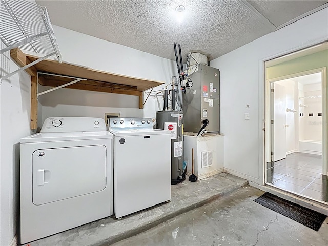 1751 Chatham Cir, Apopka, FL 32703 - washroom with electric water heater, washer and clothes dryer, a textured ceiling, and heating unit