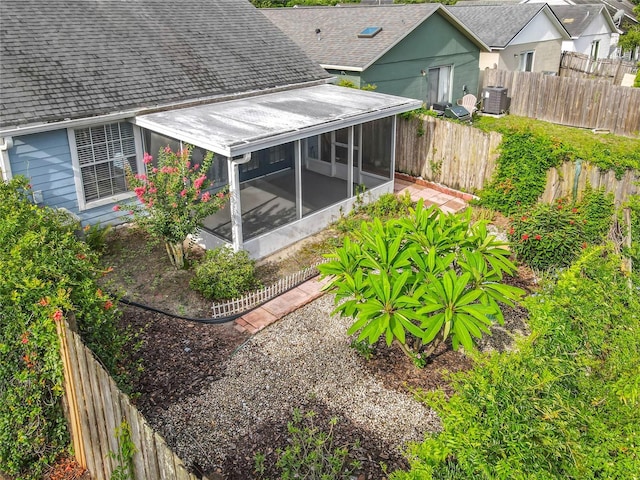 1751 Chatham Cir, Apopka, FL 32703 - back of house with a sunroom, roof with shingles, and a fenced backyard