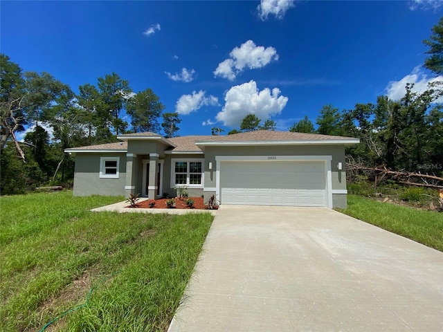 16832 SW 41st Avenue Rd, Ocala, FL 34473 - prairie-style home featuring stucco siding, an attached garage, driveway, and a front yard