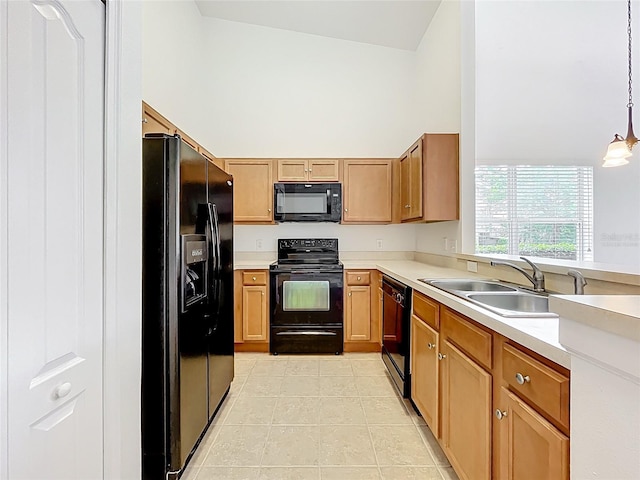 2092 Switch Grass Cir, Ocoee, FL 34761 - kitchen with black appliances, light countertops, hanging light fixtures, a high ceiling, and light tile patterned flooring