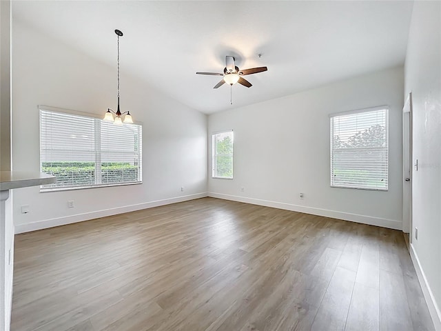 2092 Switch Grass Cir, Ocoee, FL 34761 - unfurnished room with ceiling fan, wood finished floors, a chandelier, and lofted ceiling