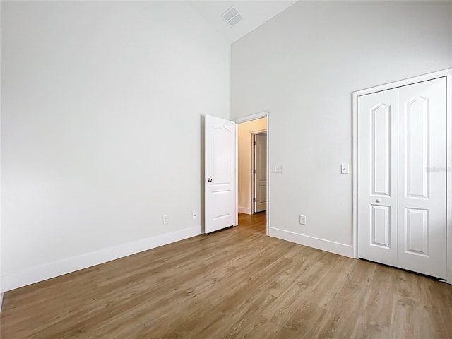 2092 Switch Grass Cir, Ocoee, FL 34761 - unfurnished bedroom with high vaulted ceiling, light wood-style floors, and a closet