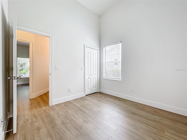 2092 Switch Grass Cir, Ocoee, FL 34761 - unfurnished bedroom with high vaulted ceiling, light wood finished floors, and a closet