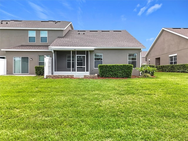 2092 Switch Grass Cir, Ocoee, FL 34761 - back of property featuring a yard, stucco siding, roof with shingles, and a sunroom