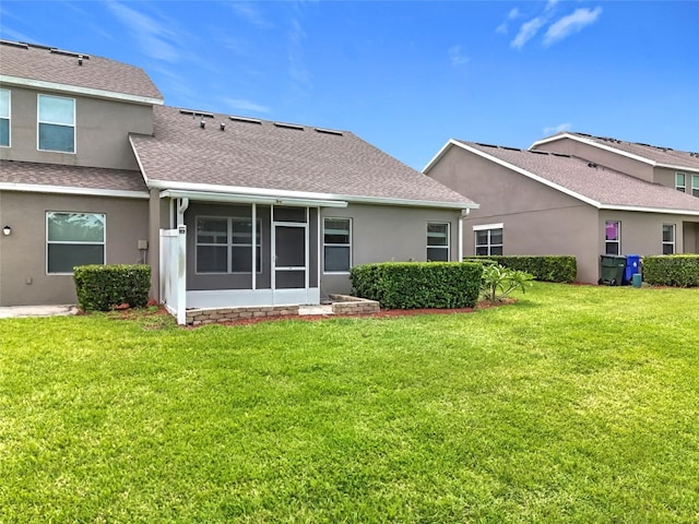 2092 Switch Grass Cir, Ocoee, FL 34761 - rear view of house with roof with shingles, a sunroom, a lawn, and stucco siding