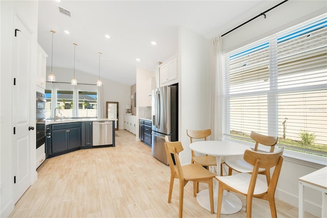 913 Sabal Breeze Ln, Apopka, FL 32703 - kitchen with appliances with stainless steel finishes, light countertops, hanging light fixtures, backsplash, and vaulted ceiling