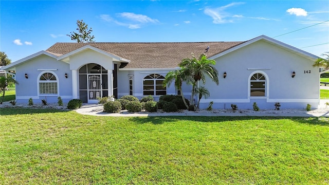 142 Broadmoor Ln, Rotonda West, FL 33947 - view of front of house with a front lawn, stucco siding, and a shingled roof