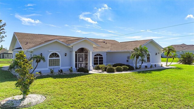 142 Broadmoor Ln, Rotonda West, FL 33947 - ranch-style house with stucco siding, a front lawn, and a shingled roof