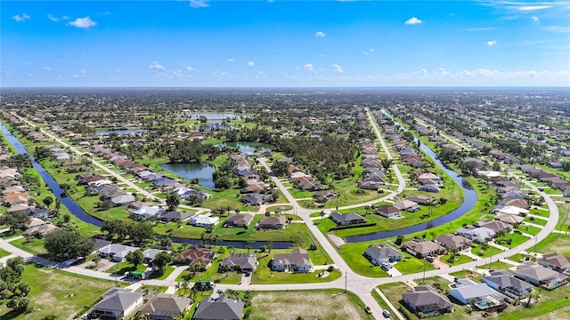 142 Broadmoor Ln, Rotonda West, FL 33947 - aerial perspective of suburban area with a nearby body of water