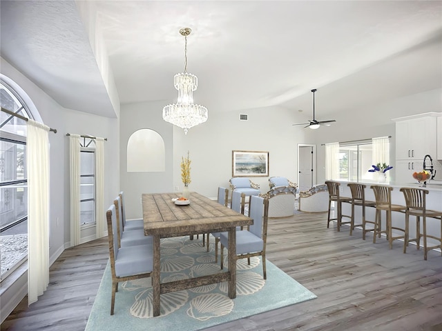 142 Broadmoor Ln, Rotonda West, FL 33947 - dining room featuring vaulted ceiling, light wood-style flooring, ceiling fan, and a chandelier