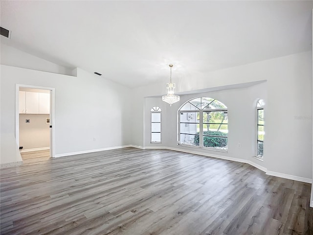 142 Broadmoor Ln, Rotonda West, FL 33947 - empty room featuring a chandelier, wood finished floors, and lofted ceiling