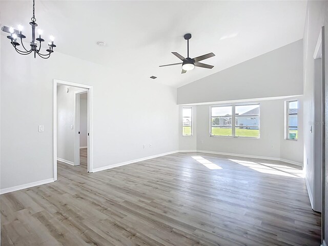 142 Broadmoor Ln, Rotonda West, FL 33947 - unfurnished room featuring a chandelier, wood finished floors, ceiling fan, and high vaulted ceiling