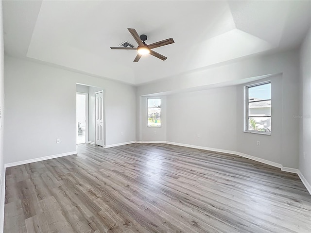 142 Broadmoor Ln, Rotonda West, FL 33947 - spare room featuring a raised ceiling, a ceiling fan, and wood finished floors