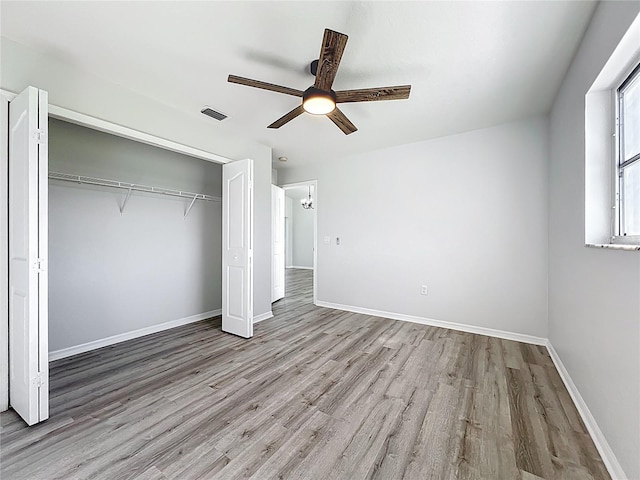 142 Broadmoor Ln, Rotonda West, FL 33947 - unfurnished bedroom with wood finished floors, a closet, and ceiling fan
