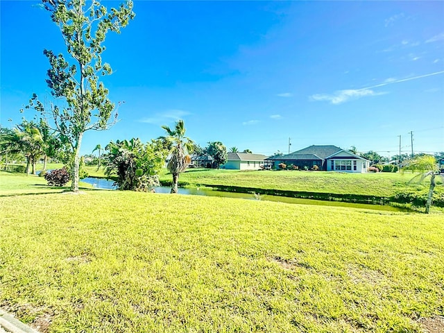 142 Broadmoor Ln, Rotonda West, FL 33947 - view of green lawn with a water view