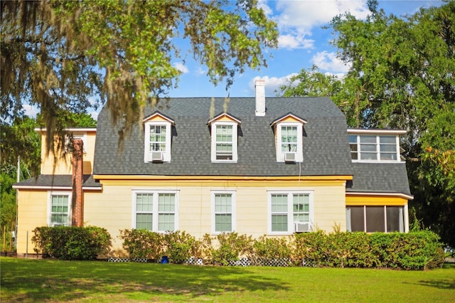 430 W Minnehaha Ave, Clermont, FL 34711 - view of front facade with a shingled roof, a chimney, a front lawn, and cooling unit