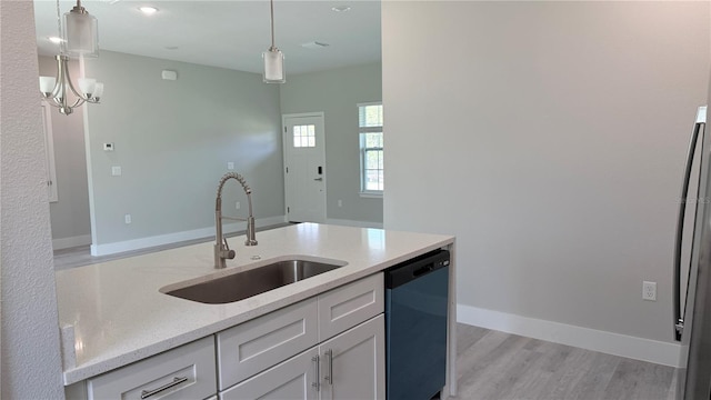 2451 W Menores Dr, Citrus Springs, FL 34434 - kitchen featuring dishwashing machine, pendant lighting, light stone counters, and white cabinetry