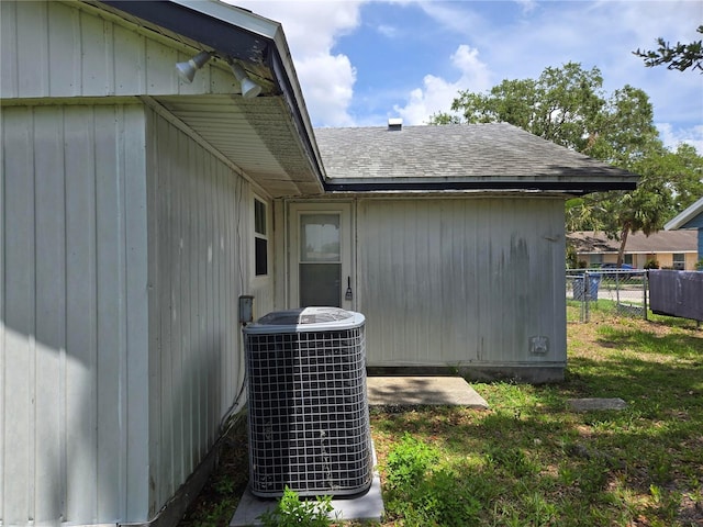 2308 18th St E, Bradenton, FL 34208 - view of home's exterior with a central AC unit and a shingled roof